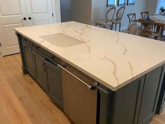 Calacatta quartz island sage cabinets World Stone Charlotte